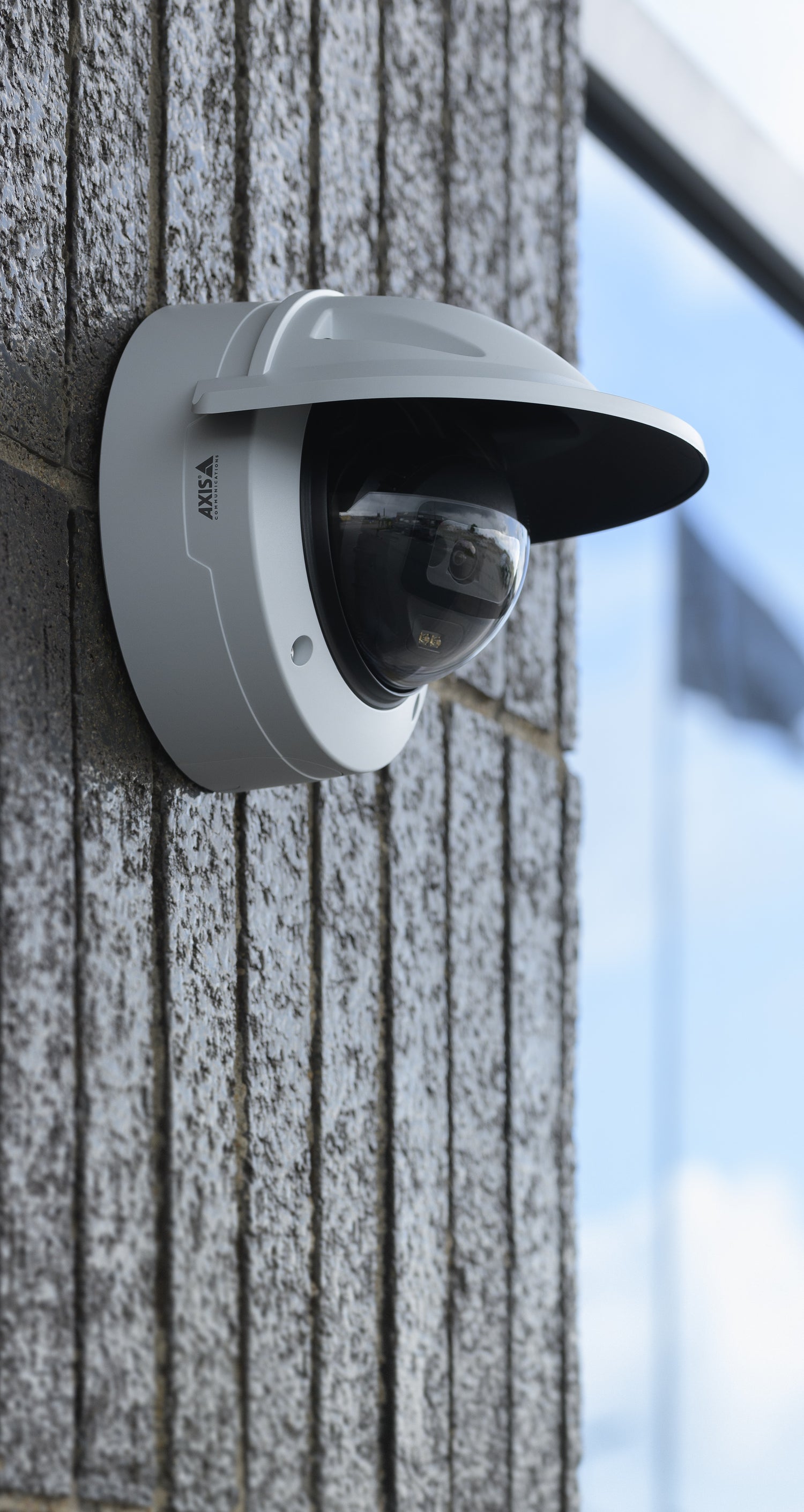 Wall mount camera on gray non uniform gray wall.
