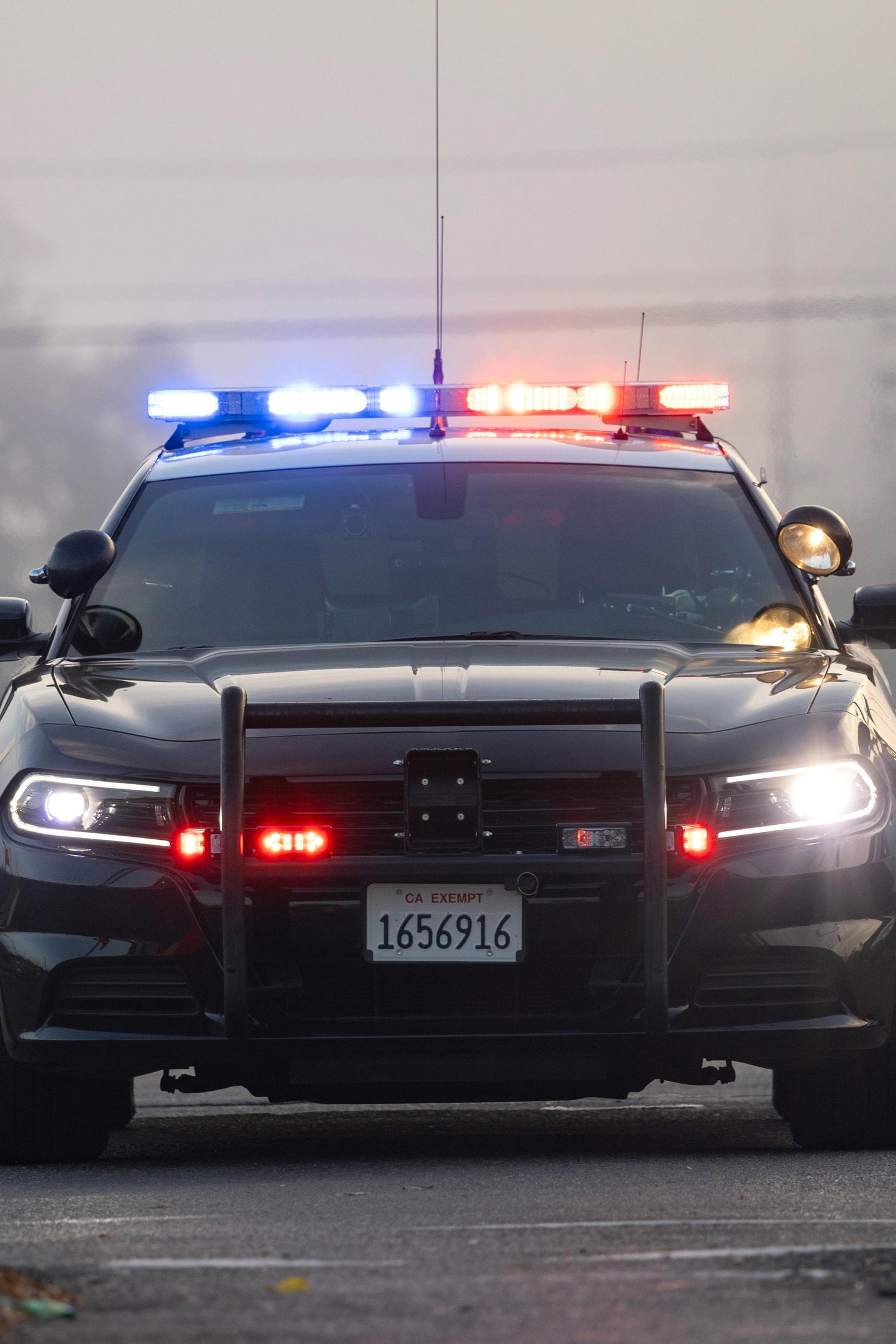 Front view of police vehicle with lights on.