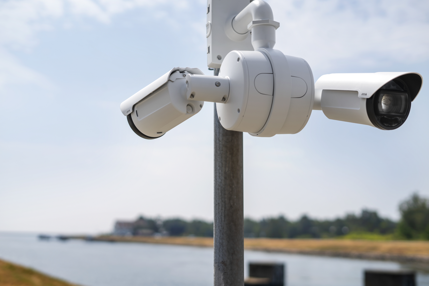 Pole mounted cameras angled to view front and back in front of a channel.