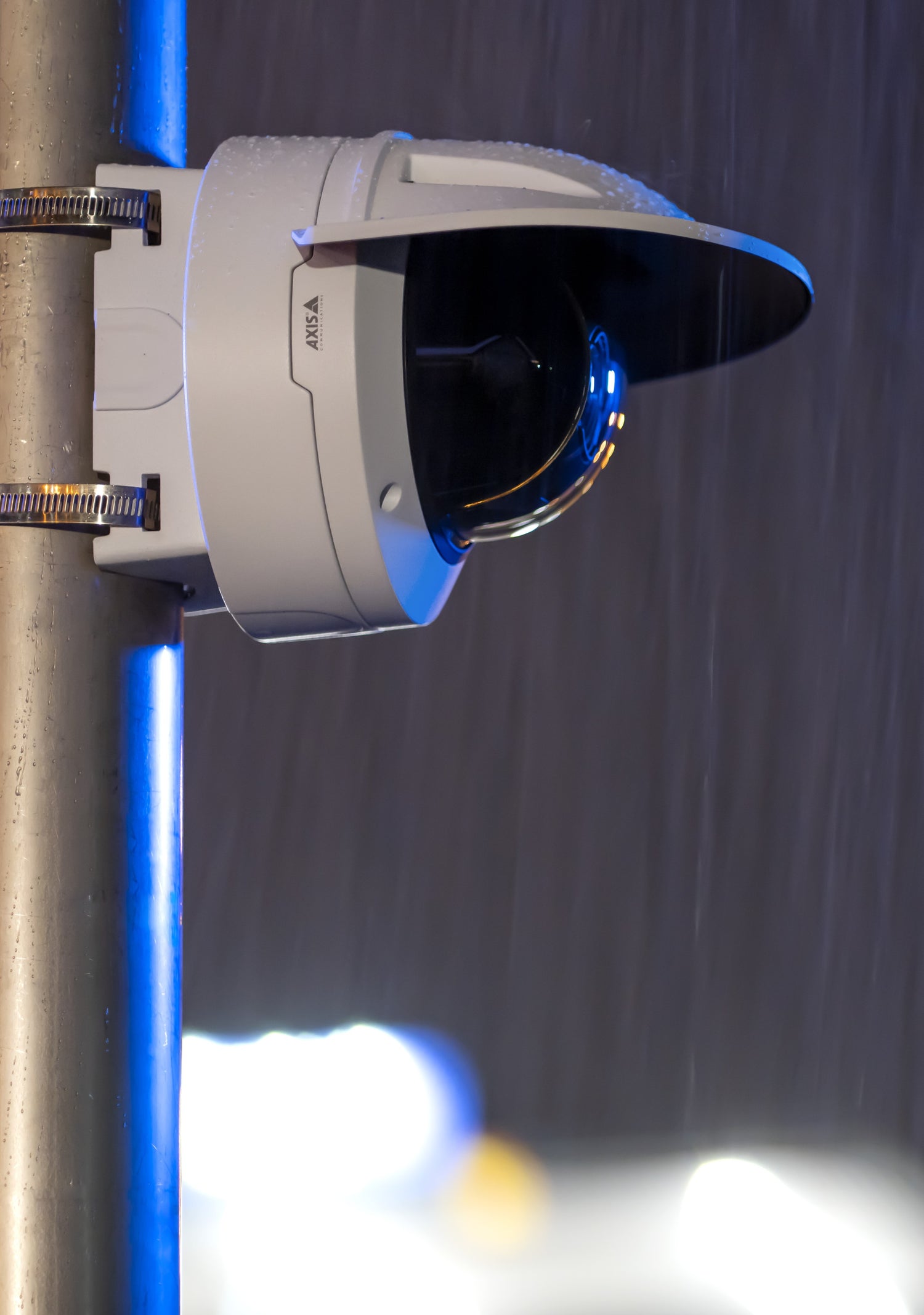 Q3546LVA Camera with weathershield blocking in from the rain at night.