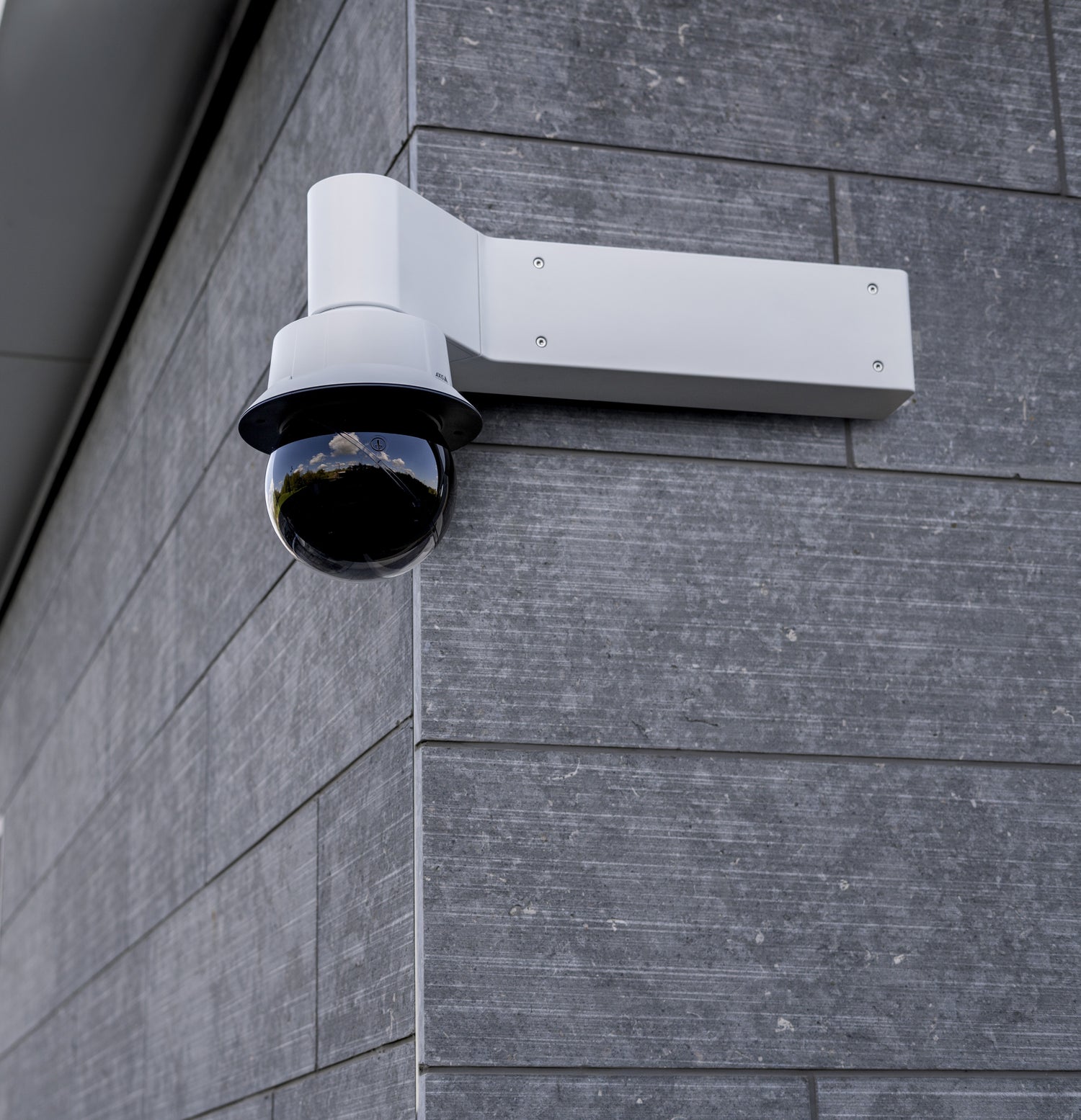 Wall mounted camera on corner of building.