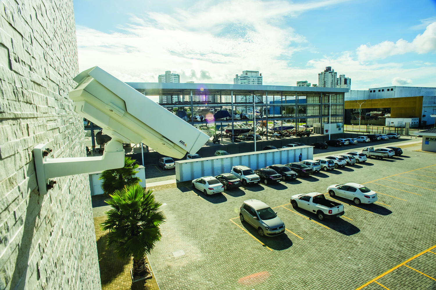 Wall mounted camera viewing marina parking lot.
